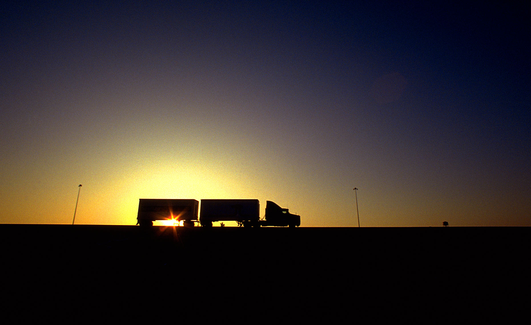 Semi-trucks-sunset-sky-1